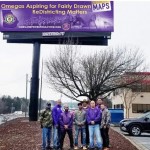 Beta Lambda Lambda brothers in front of the billboard